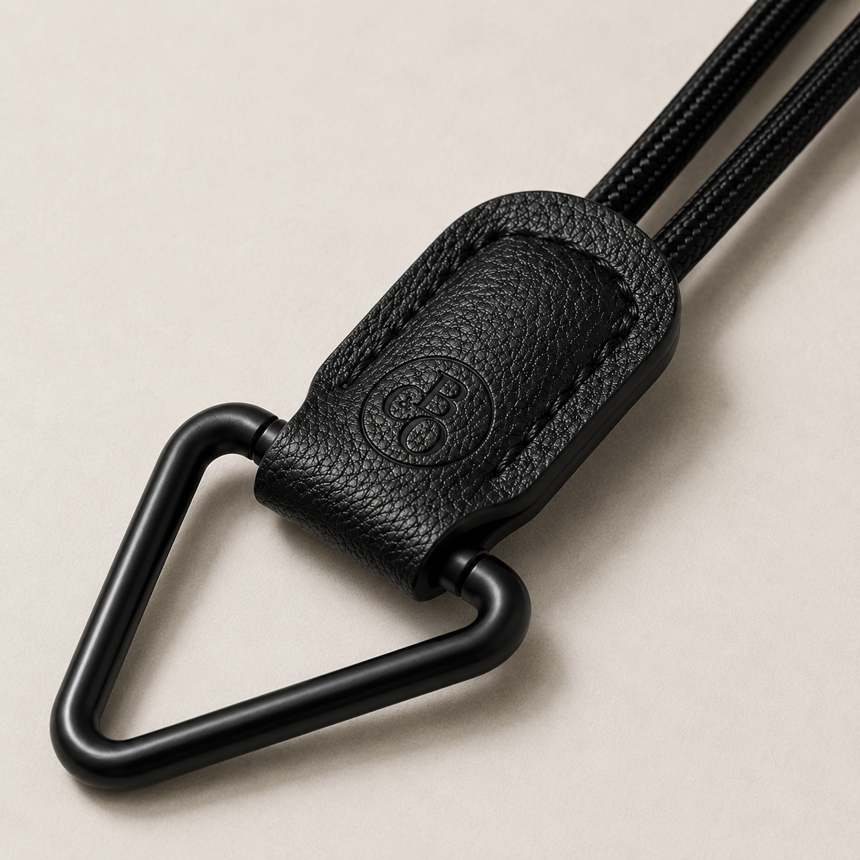 Close detail of The Signature's embossed holder and matte-black triangular loop