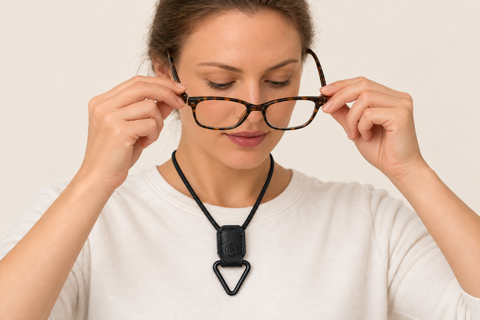 Eyewear being removed before it is placed into The Signature Eyewear Necklace